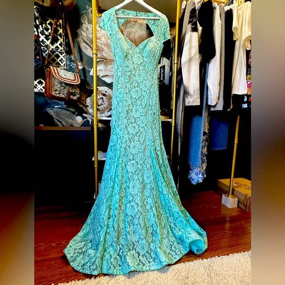 Prom stunning.It implies nude open backthe train elongates the silhouette.
